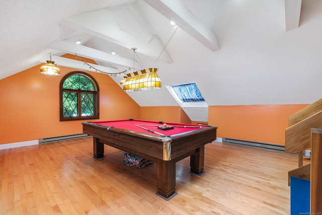 playroom featuring vaulted ceiling with skylight, light wood-type flooring, and a baseboard heating unit