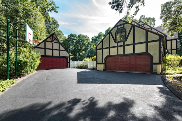 detached garage featuring fence