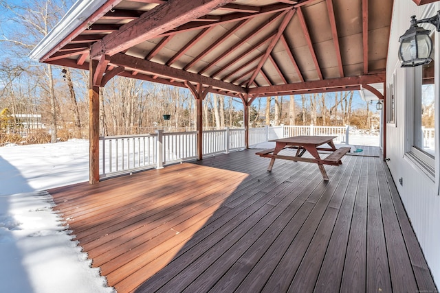 snow covered deck with outdoor dining space and a gazebo