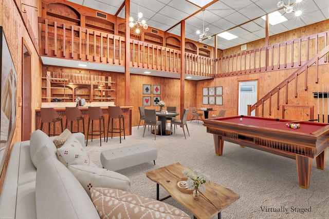 game room featuring carpet, pool table, a notable chandelier, and wooden walls