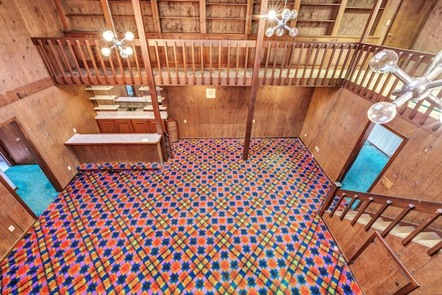 interior space with wood walls and an inviting chandelier