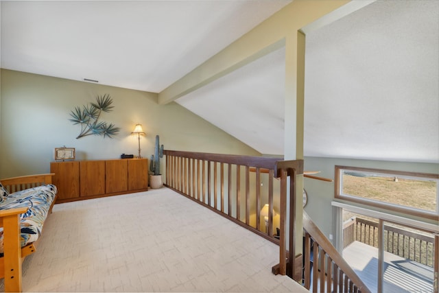 hallway with visible vents and vaulted ceiling with beams