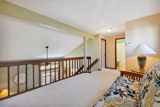 living area with an upstairs landing, light colored carpet, baseboards, and vaulted ceiling with beams