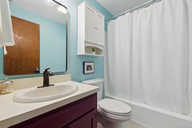 bathroom featuring shower / bath combo with shower curtain, a textured ceiling, toilet, and vanity