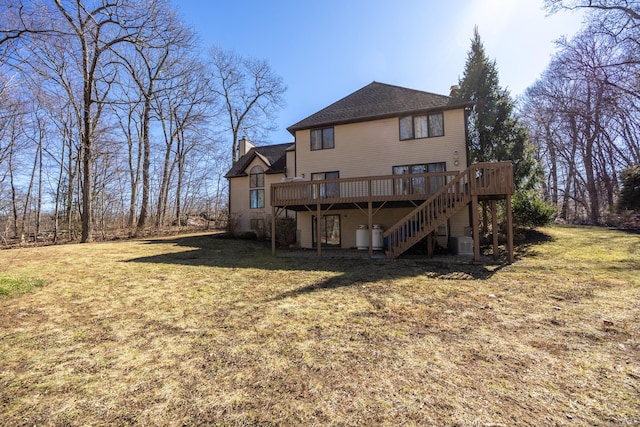 rear view of property featuring stairway, central AC unit, a wooden deck, a yard, and a chimney