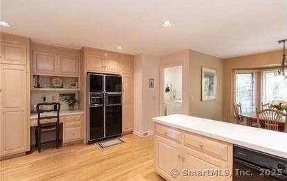 kitchen featuring recessed lighting, light brown cabinetry, black appliances, light countertops, and light wood-style floors