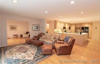 living area with recessed lighting and light wood-type flooring