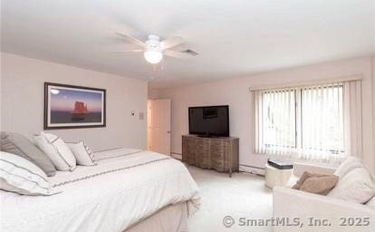 bedroom featuring a baseboard radiator, light colored carpet, and ceiling fan