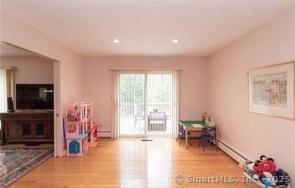 game room with recessed lighting, light wood-type flooring, and baseboard heating