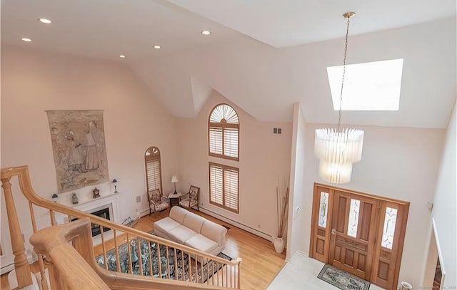 7 Canterbury Ln, Monroe, CT 06468 - foyer featuring a chandelier, high vaulted ceiling, wood finished floors, a fireplace, and recessed lighting