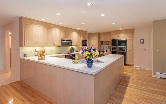 7 Canterbury Ln, Monroe, CT 06468 - kitchen with black appliances, light wood-style floors, light countertops, a peninsula, and recessed lighting