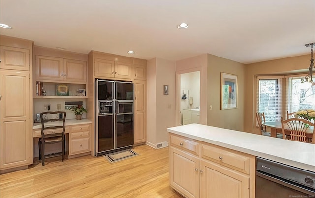 7 Canterbury Ln, Monroe, CT 06468 - kitchen with black fridge with ice dispenser, washer and clothes dryer, light brown cabinetry, light countertops, and light wood finished floors