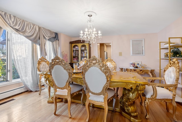7 Canterbury Ln, Monroe, CT 06468 - dining space featuring a chandelier, wood finished floors, and a baseboard radiator