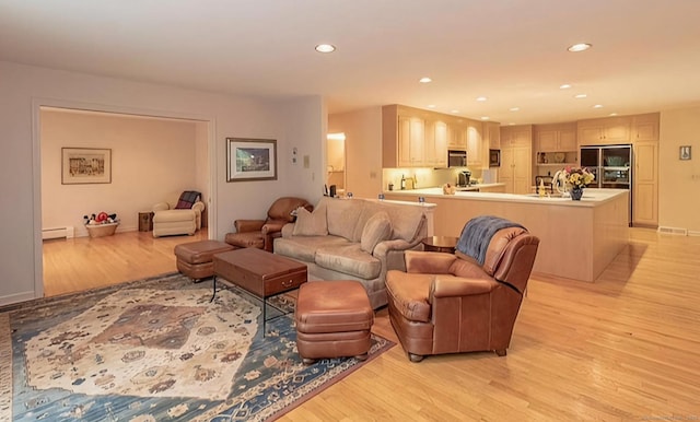 7 Canterbury Ln, Monroe, CT 06468 - living room with light wood-style flooring, a baseboard radiator, and recessed lighting
