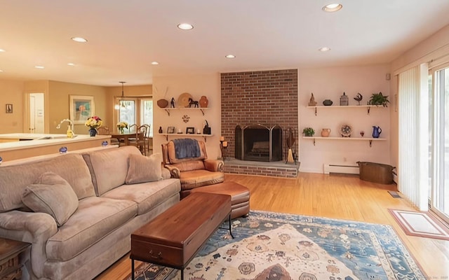 7 Canterbury Ln, Monroe, CT 06468 - living room with wood finished floors, a baseboard radiator, recessed lighting, and a fireplace