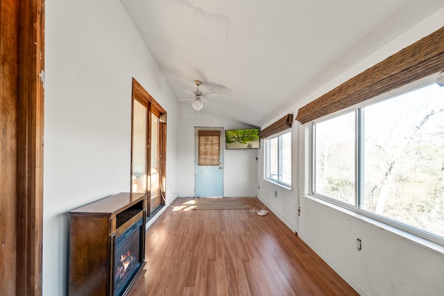 unfurnished sunroom featuring lofted ceiling and a ceiling fan