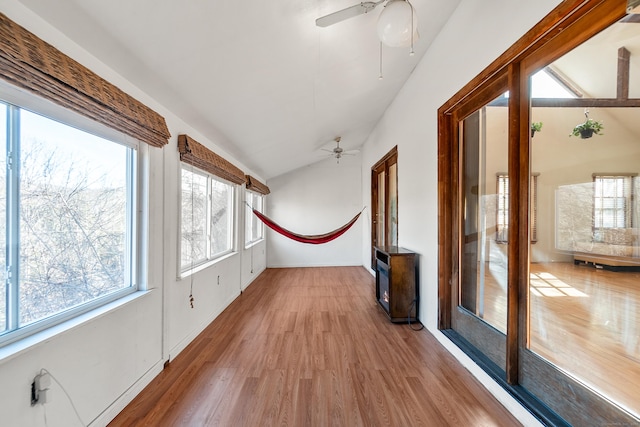 unfurnished sunroom with vaulted ceiling and ceiling fan