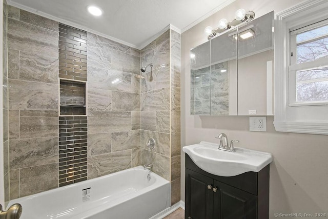 bathroom featuring ornamental molding, shower / washtub combination, and vanity