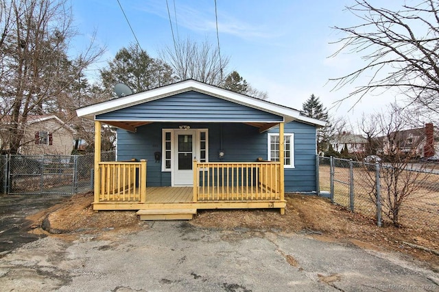 view of front of home featuring covered porch, a gate, and fence