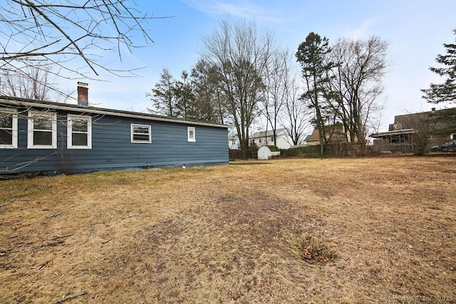 view of yard featuring an outbuilding and fence