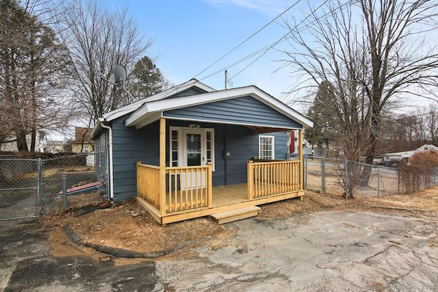 view of front of property featuring covered porch, fence, and a gate