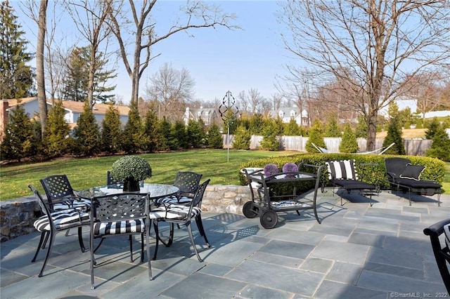 view of patio / terrace with outdoor dining space and fence