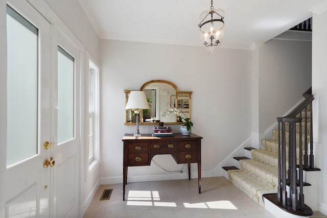 foyer with visible vents, stairs, baseboards, and ornamental molding