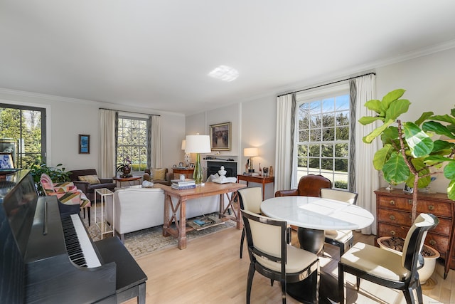 dining room featuring light wood-type flooring and ornamental molding