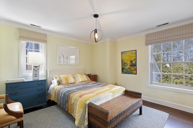 bedroom featuring visible vents, dark wood-style floors, baseboards, and ornamental molding