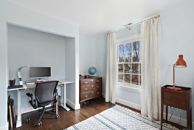 office space featuring visible vents, baseboards, and wood finished floors