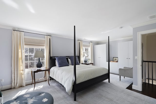 bedroom featuring visible vents, baseboards, ornamental molding, and carpet flooring