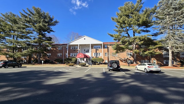 view of property featuring uncovered parking