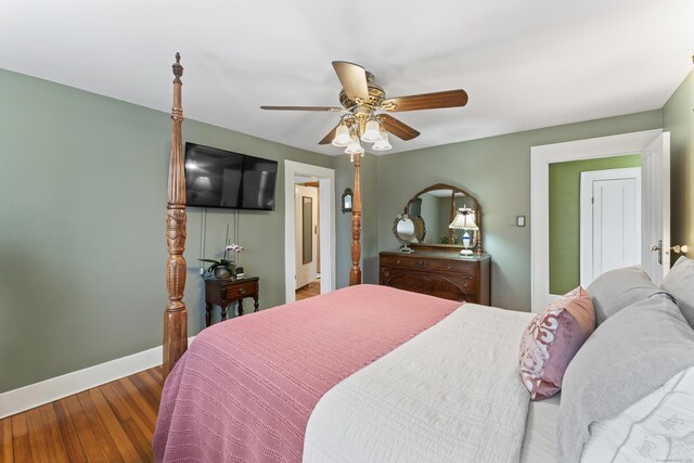 bedroom featuring ceiling fan, wood finished floors, and baseboards