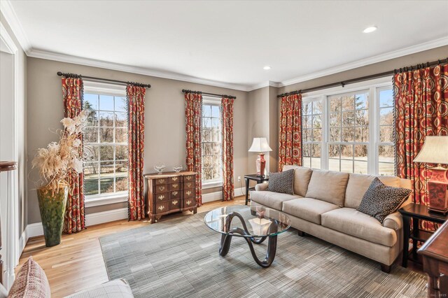 living room with recessed lighting, crown molding, baseboards, and wood finished floors