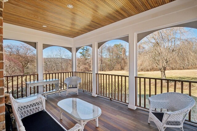 sunroom featuring wooden ceiling