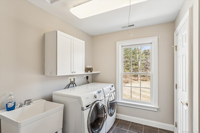 laundry room with baseboards, visible vents, cabinet space, a sink, and independent washer and dryer