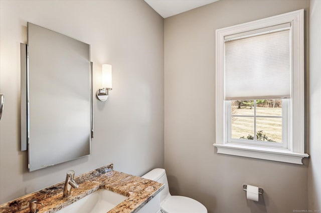 bathroom with toilet and vanity