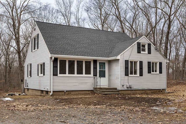 cape cod house with roof with shingles