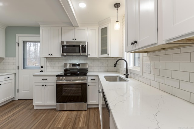 kitchen featuring white cabinetry, tasteful backsplash, appliances with stainless steel finishes, and a sink