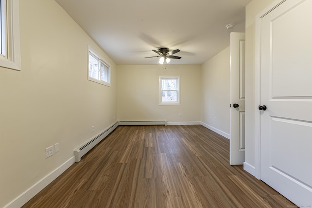 spare room with ceiling fan, a baseboard radiator, baseboards, and dark wood-style floors