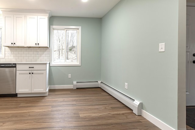 unfurnished dining area featuring baseboards, baseboard heating, and light wood-style flooring