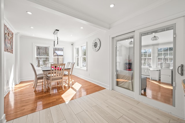 dining room featuring light wood finished floors, recessed lighting, and crown molding