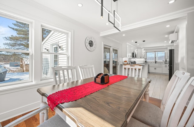 dining space with an AC wall unit, ornamental molding, recessed lighting, and light wood-style floors