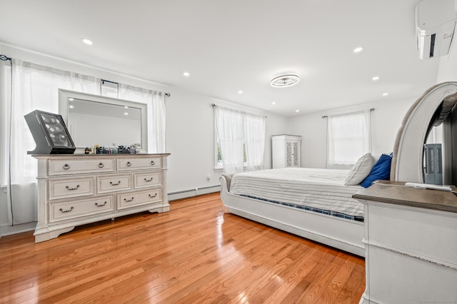 bedroom with light wood finished floors, a wall mounted AC, a baseboard heating unit, and recessed lighting