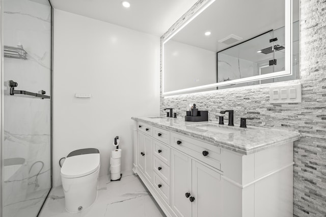 full bath with double vanity, a marble finish shower, toilet, marble finish floor, and a sink