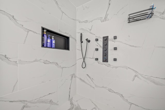 interior space featuring a marble finish shower