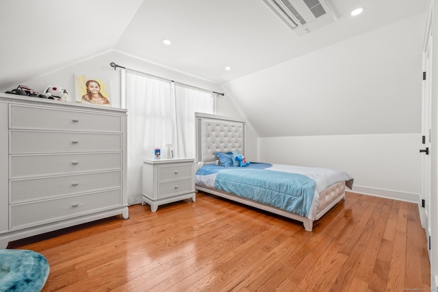 bedroom featuring light wood-type flooring, visible vents, vaulted ceiling, and recessed lighting