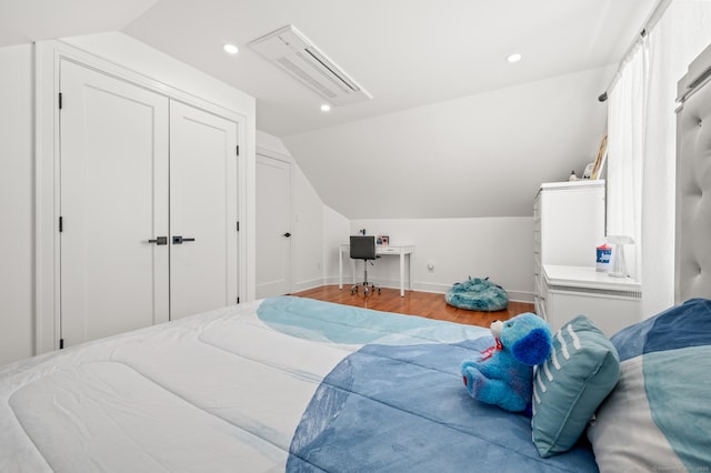 bedroom featuring visible vents, baseboards, wood finished floors, vaulted ceiling, and recessed lighting