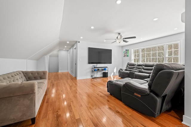 living room with light wood finished floors, recessed lighting, a ceiling fan, vaulted ceiling, and baseboards