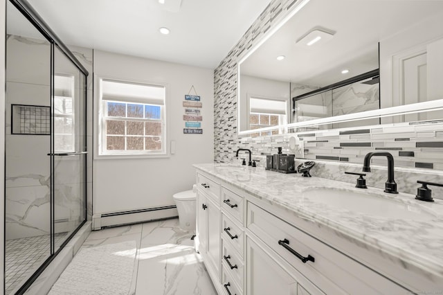 full bathroom featuring marble finish floor, baseboard heating, plenty of natural light, and a sink